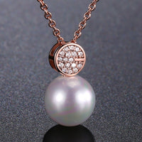 Side angle view of KHAISTA simulated pearl dazzling pendant necklace