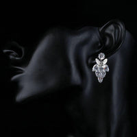 Side angle view of KHAISTA sitting butterfly crystal drop earrings