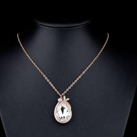 Side angle view of KHAISTA butterfly on large crystal pendant necklace