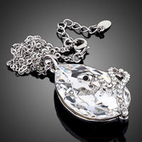 Side angle view of KHAISTA sleeping snake crystal chain necklace
