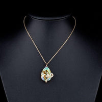 Close up detail of KHAISTA sleeping snake crystal pendant necklace