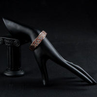 Side angle view of KHAISTA sparkling crystal cuff bangle