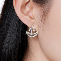 Close up of KHAISTA sparkling cubic zircon stud earrings