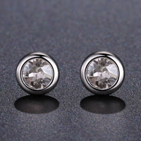 Side angle view of KHAISTA sparkling round crystal stud earrings