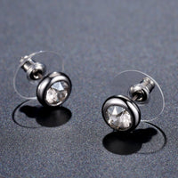 Close up of KHAISTA sparkling round crystal stud earrings