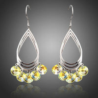 Side angle view of KHAISTA sparkly crystal drop hook earrings