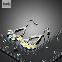 Close up of KHAISTA sparkly crystal drop hook earrings