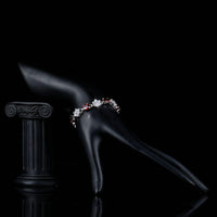 Side angle view of KHAISTA sparkling floral design bracelet