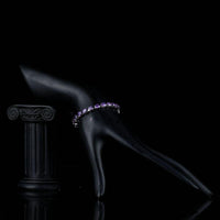 Side angle view of KHAISTA purple crystal lobster bracelet