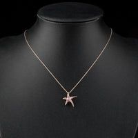 Side angle view of KHAISTA crystal starfish pendant necklace