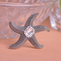 Side angle view of Khaista crystal starfish brooch