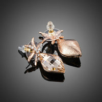 Close up of KHAISTA starfish rhinestone drop earrings