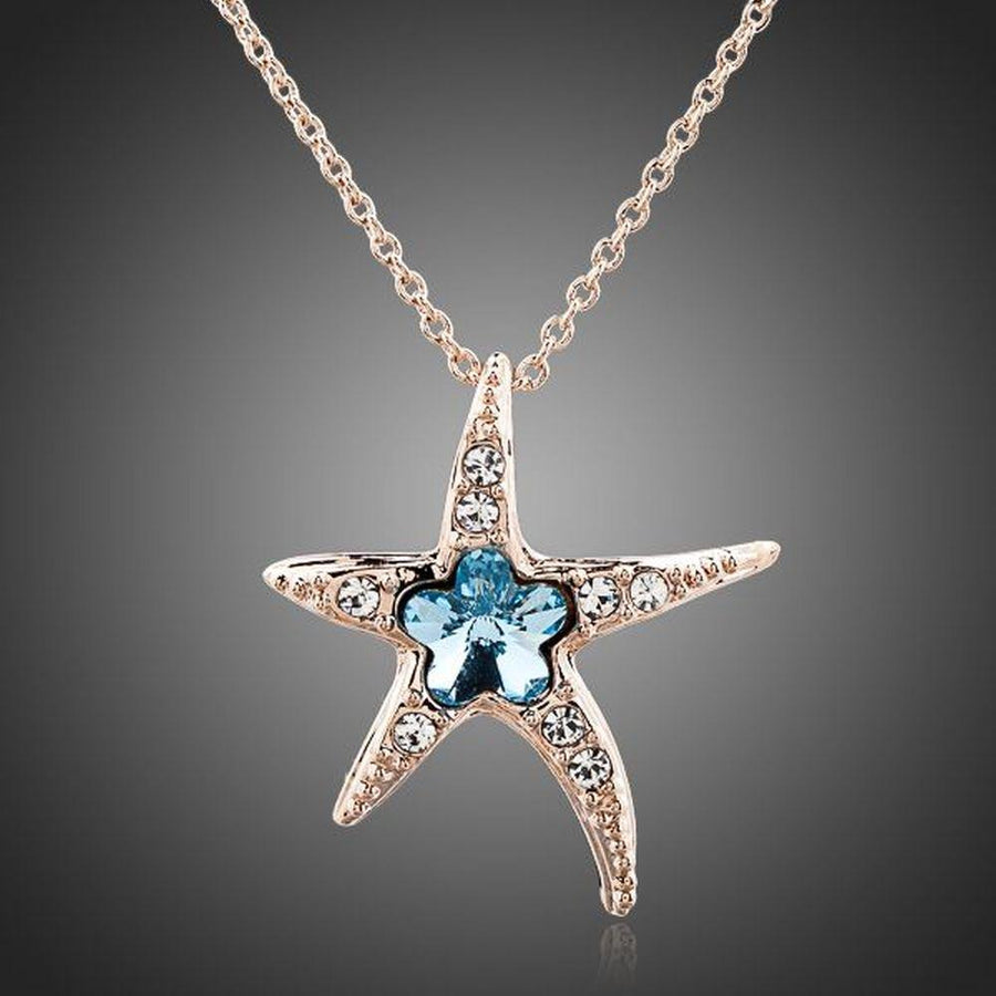 KHAISTA starfish blue crystal flower necklace on white background
