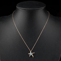 Close up detail of KHAISTA starfish blue crystal flower necklace