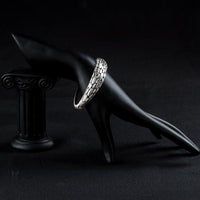 Side angle view of KHAISTA stone wall design crystal bangle