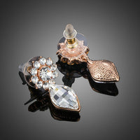 Close up of KHAISTA sunflower crystal drop earrings