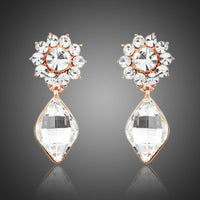 KHAISTA sunflower crystal drop earrings on white background