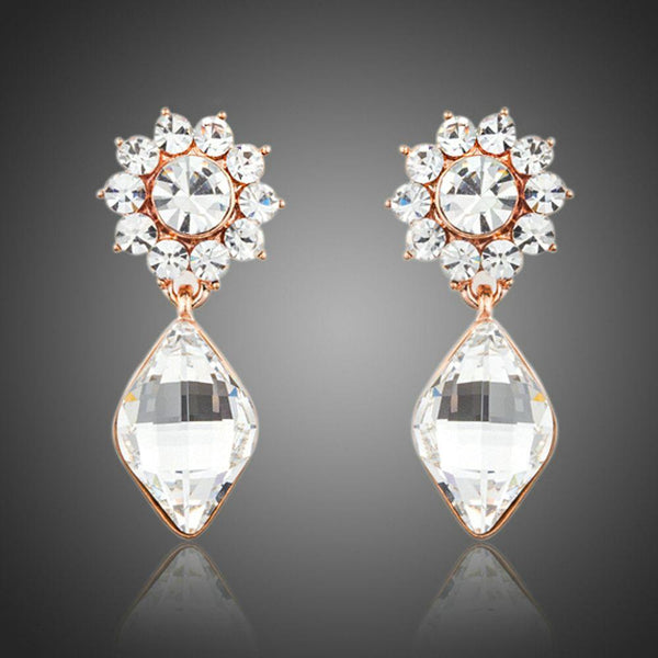 KHAISTA sunflower crystal drop earrings on white background