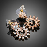 Close up of KHAISTA sunflower design crystal drop earrings