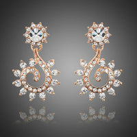 KHAISTA sunflower design crystal drop earrings on white background