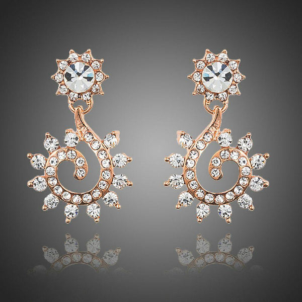 KHAISTA sunflower design crystal drop earrings on white background