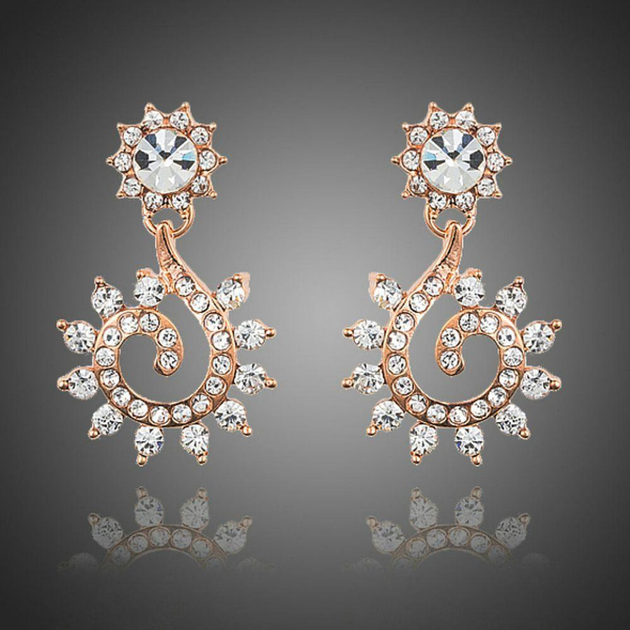KHAISTA sunflower design crystal drop earrings on white background