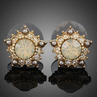 KHAISTA sunflower design crystal stud earrings on white background
