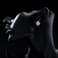 Side angle view of KHAISTA sunflower design crystal stud earrings