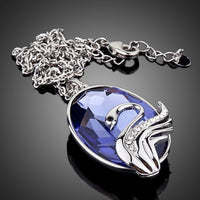 Close up detail of KHAISTA swan crystal link chain necklace