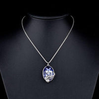 Side angle view of KHAISTA swan crystal link chain necklace