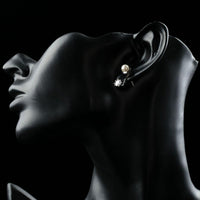 Side angle view of KHAISTA synthetic pearl stud earrings
