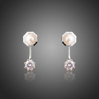 KHAISTA synthetic pearl stud earrings on white background