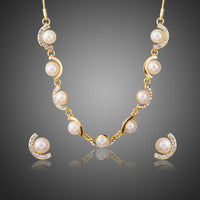 Khaista pearl charm necklace and earrings set on white background