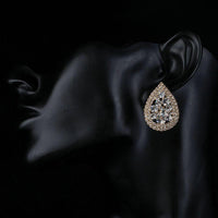Close up of KHAISTA teardrop design crystal stud earrings