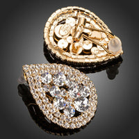 Side angle view of KHAISTA teardrop design crystal stud earrings
