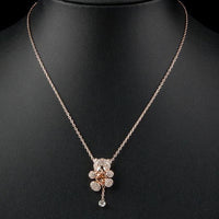 Close up detail of KHAISTA champagne crystal teddy bear necklace