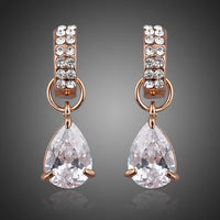 KHAISTA transparent CZ raindrop earrings on white background