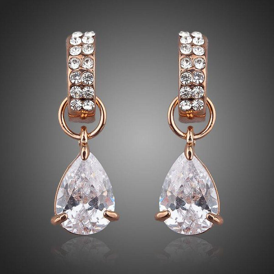 KHAISTA transparent CZ raindrop earrings on white background