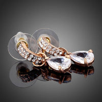 Close up of KHAISTA transparent CZ raindrop earrings