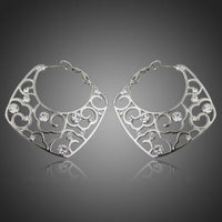 KHAISTA transparent Stellux Austrian hoop earrings on white background