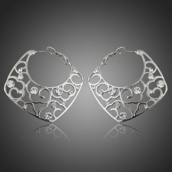 KHAISTA transparent Stellux Austrian hoop earrings on white background