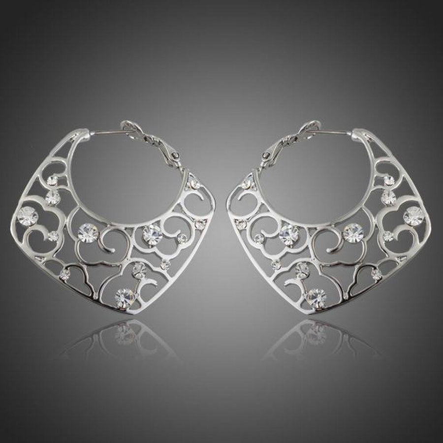 KHAISTA transparent Stellux Austrian hoop earrings on white background