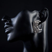 Close up of KHAISTA transparent Stellux Austrian hoop earrings