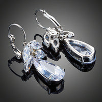 Close up of KHAISTA tree design CZ drop earrings