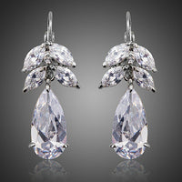 KHAISTA tree design CZ drop earrings on white background