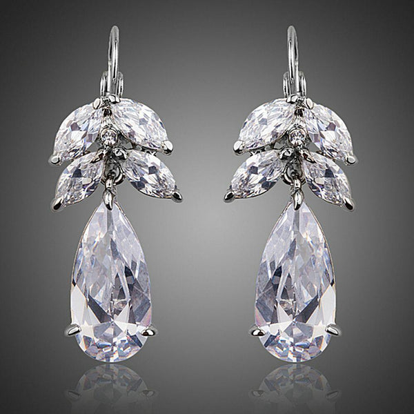 KHAISTA tree design CZ drop earrings on white background