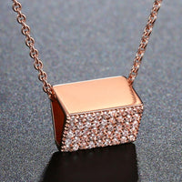 Side angle view of KHAISTA purse shape rectangle CZ pendant necklace