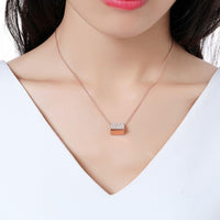 Close up detail of KHAISTA purse shape rectangle CZ pendant necklace