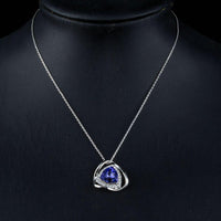 Side angle view of KHAISTA triangular royal blue crystal pendant necklace