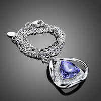 Close up detail of KHAISTA triangular royal blue crystal pendant necklace